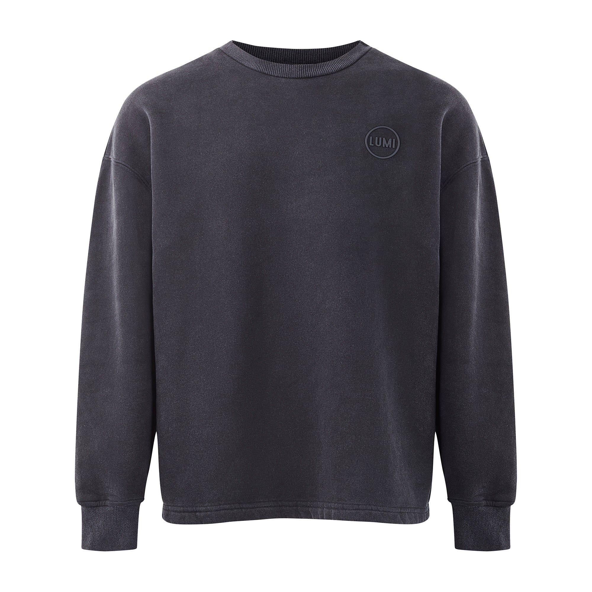 Unisex LUX Oversized Sweatshirt Black Wash featuring a minimalist design with crew neck and long sleeves, showcasing a subtle raised rubber LUMI logo on chest. Premium cotton blend fabric in a washed black finish, displaying relaxed shoulders and ribbed cuffs for a contemporary oversized silhouette.