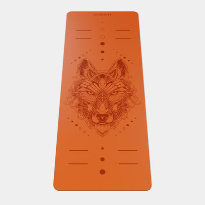 Eco Wolf Yoga Mat featuring an intricate geometric wolf head design in terracotta orange color. Non-slip 4mm thick mat with alignment markers and positioning dots, showcasing detailed tribal-style wolf artwork centered on the mat with Luna & Wolf branding.