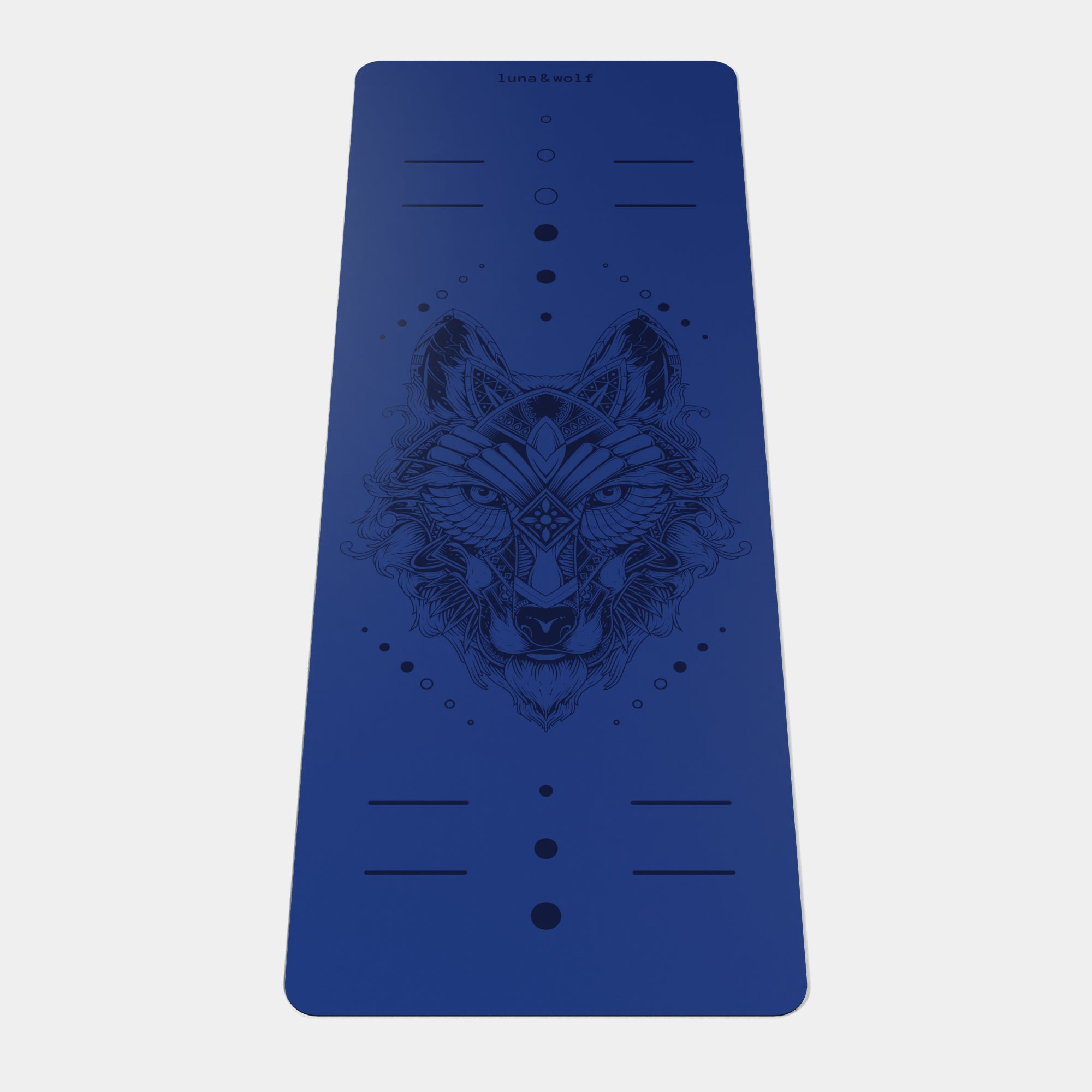 Eco Wolf Yoga Mat featuring a deep navy blue non-slip surface with geometric wolf head design and alignment markers. Premium 4mm thick eco-friendly exercise mat with detailed tribal-style wolf illustration centered on mat.