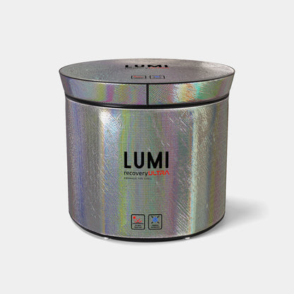 LUMI Ultra Cover, a cylindrical iridescent ice bath cover with holographic silver finish, featuring a zip-top lid and brand logo. The thermal insulating wrap displays shifting rainbow colors and has a sleek, modern design for premium ice bath protection.