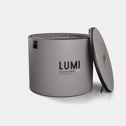 Pod PRO Ice Barrel in stone grey and black finish, featuring LUMI branding, shown with removable lid partially open revealing interior filled with ice water. Modern cylindrical design with ribbed exterior texture and professional-grade construction for cold therapy treatment.