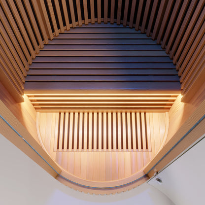 LUMI Sauna PRO interior view showcasing premium Hemlock wood slats in curved architectural design, with warm ambient lighting highlighting the elegant barrel-vault ceiling and minimalist Scandinavian craftsmanship.